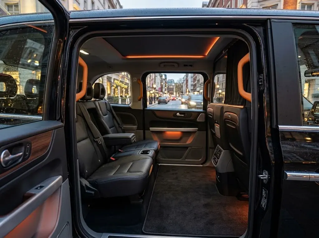 Taxi interior with black leather seats and warm ambient lighting